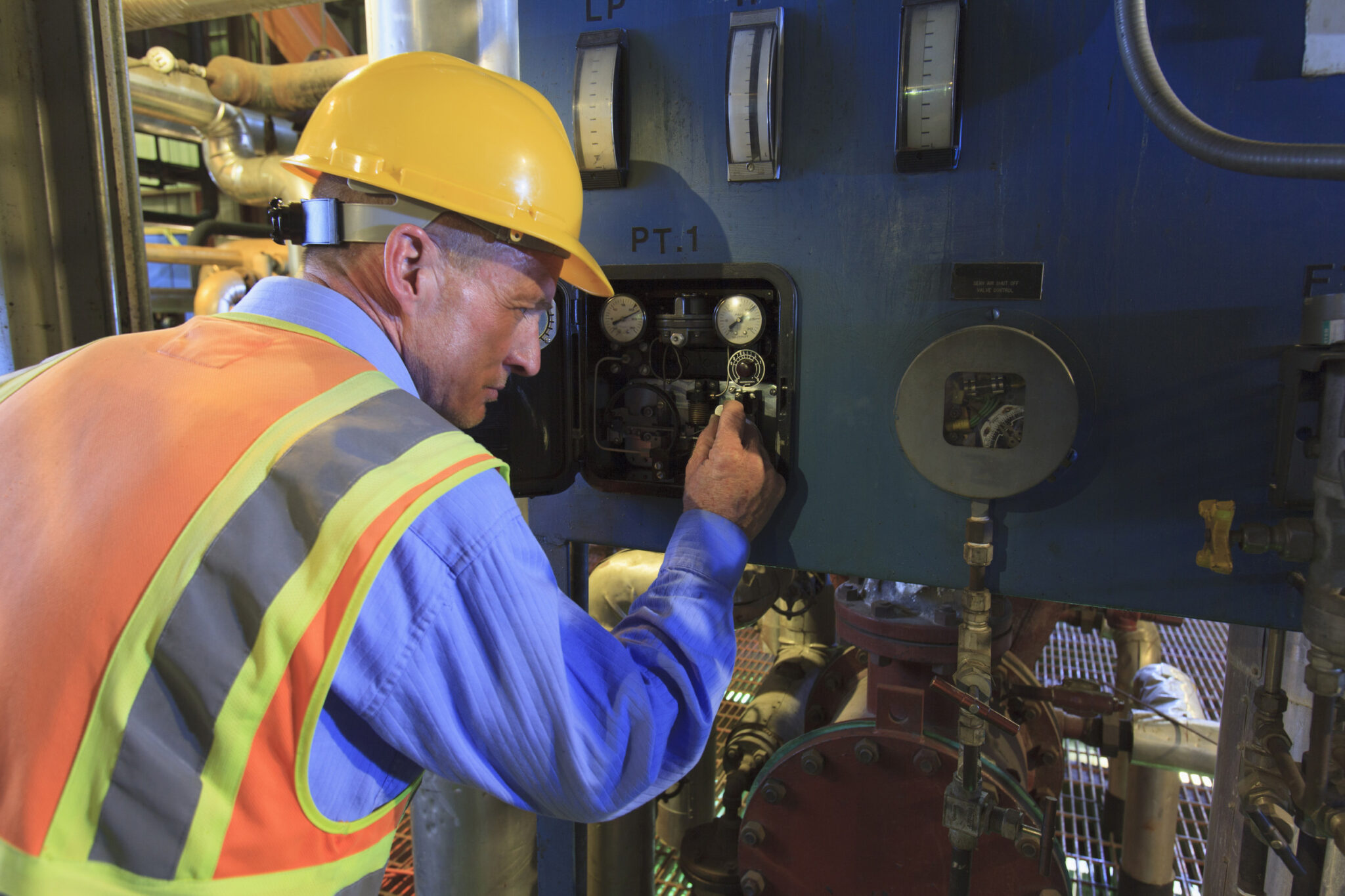 Engineer in electric power plant reviewing sensor readings