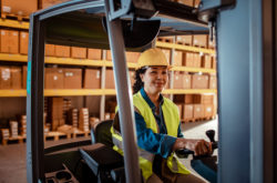 Close up of a female forklift driver working in a warehouse