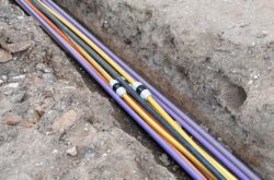 underground electric cable infrastructure installation. Construction site with A lot of communication Cables protected in tubes. electric and high-speed Internet Network cables are buried underground on the street